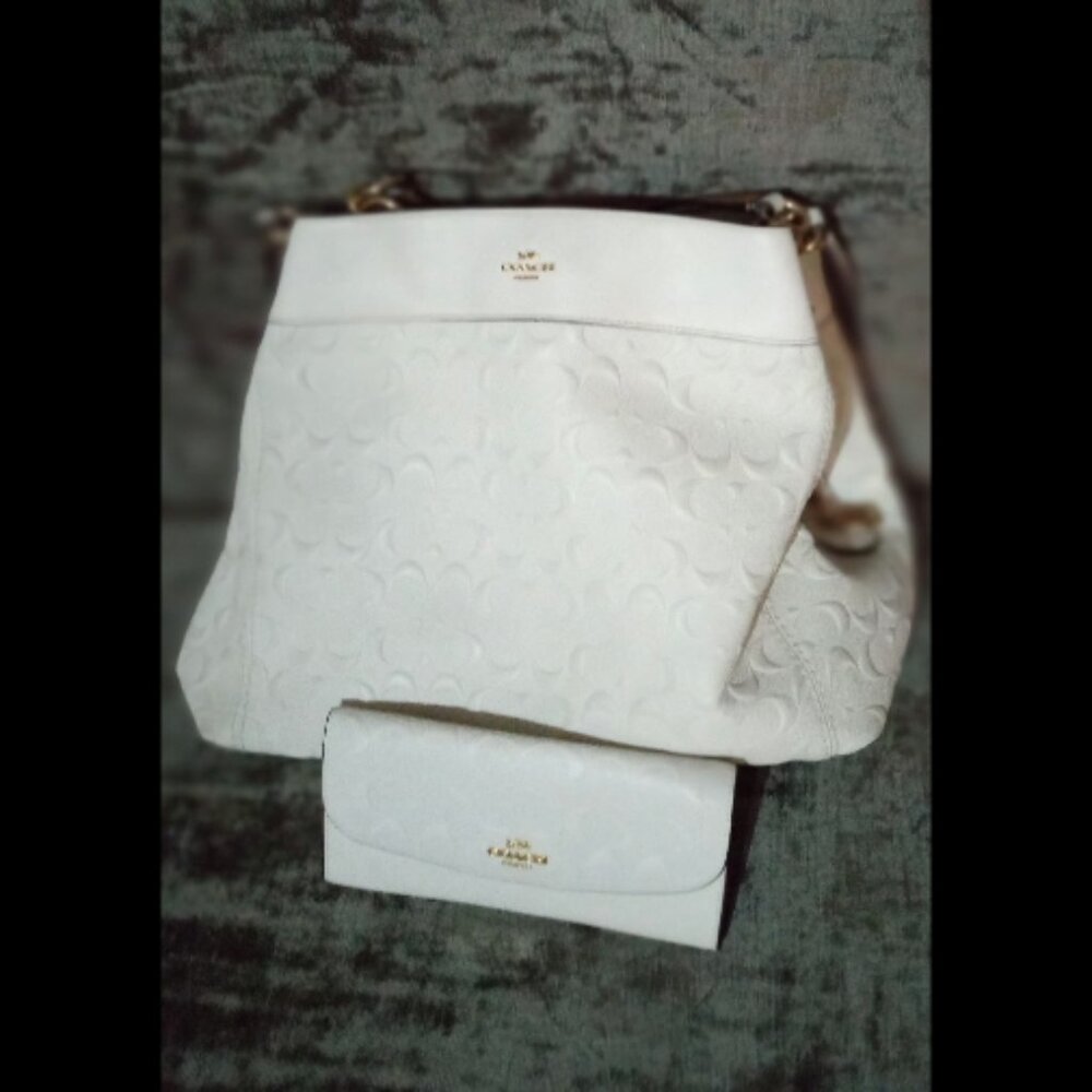 chalk white COACH purse and matching wallet.